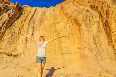 Full length of woman standing on rock