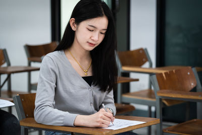 Young woman sitting on table