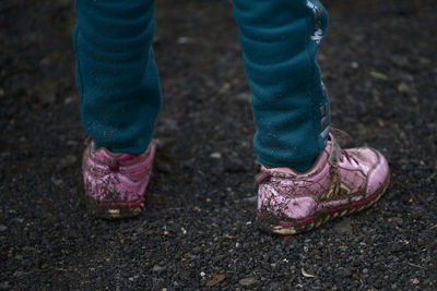 Low section of person standing on mud