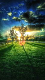 Scenic view of grassy field against cloudy sky