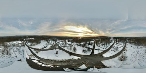 Scenic view of snow covered canal against sky