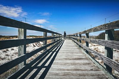 Bridge over footbridge against blue sky