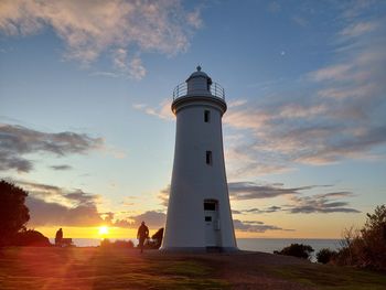 Mersey lighthouse by sea against sky during sunset in devonport, tasmania, australia.