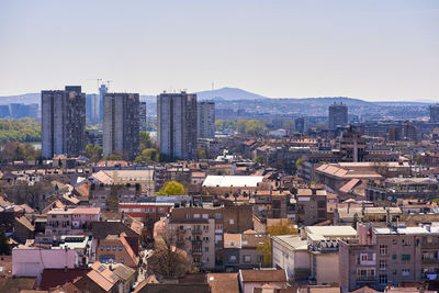 High angle view of buildings in city against clear sky