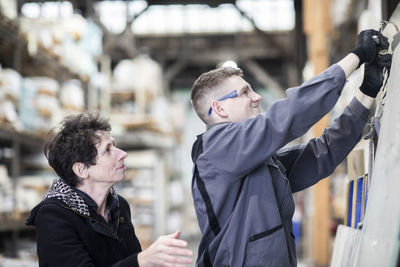 Technician man and ware house leader woman working in a store