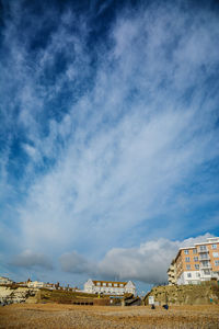Houses on field against sky