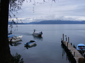 Boats moored on sea against sky