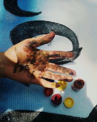 High angle view of man holding hands on table