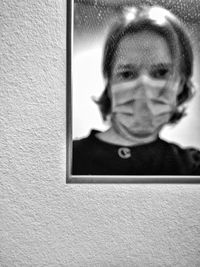 Portrait of man photographing against wall