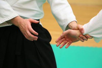 Man with trainer practicing aikido