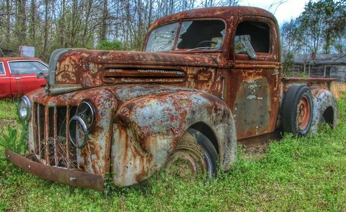 Abandoned car on dirt road