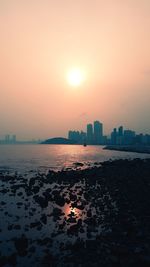 Scenic view of buildings against sky during sunset