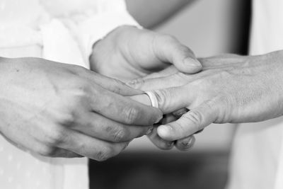Midsection of couple holding hands