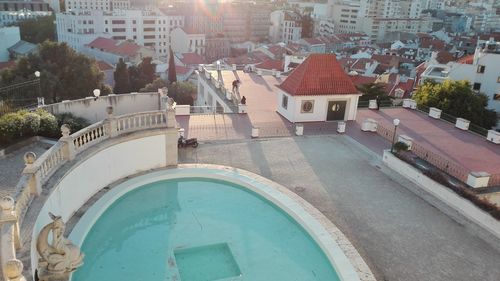 High angle view of swimming pool by buildings in town