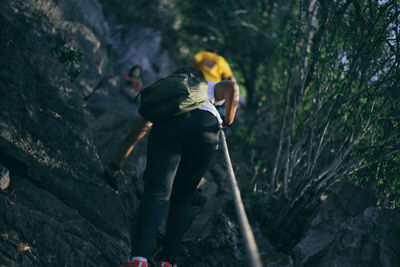 Low angle view of hikers climbing mountain