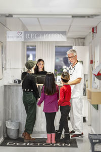 People at reception in doctor's surgery