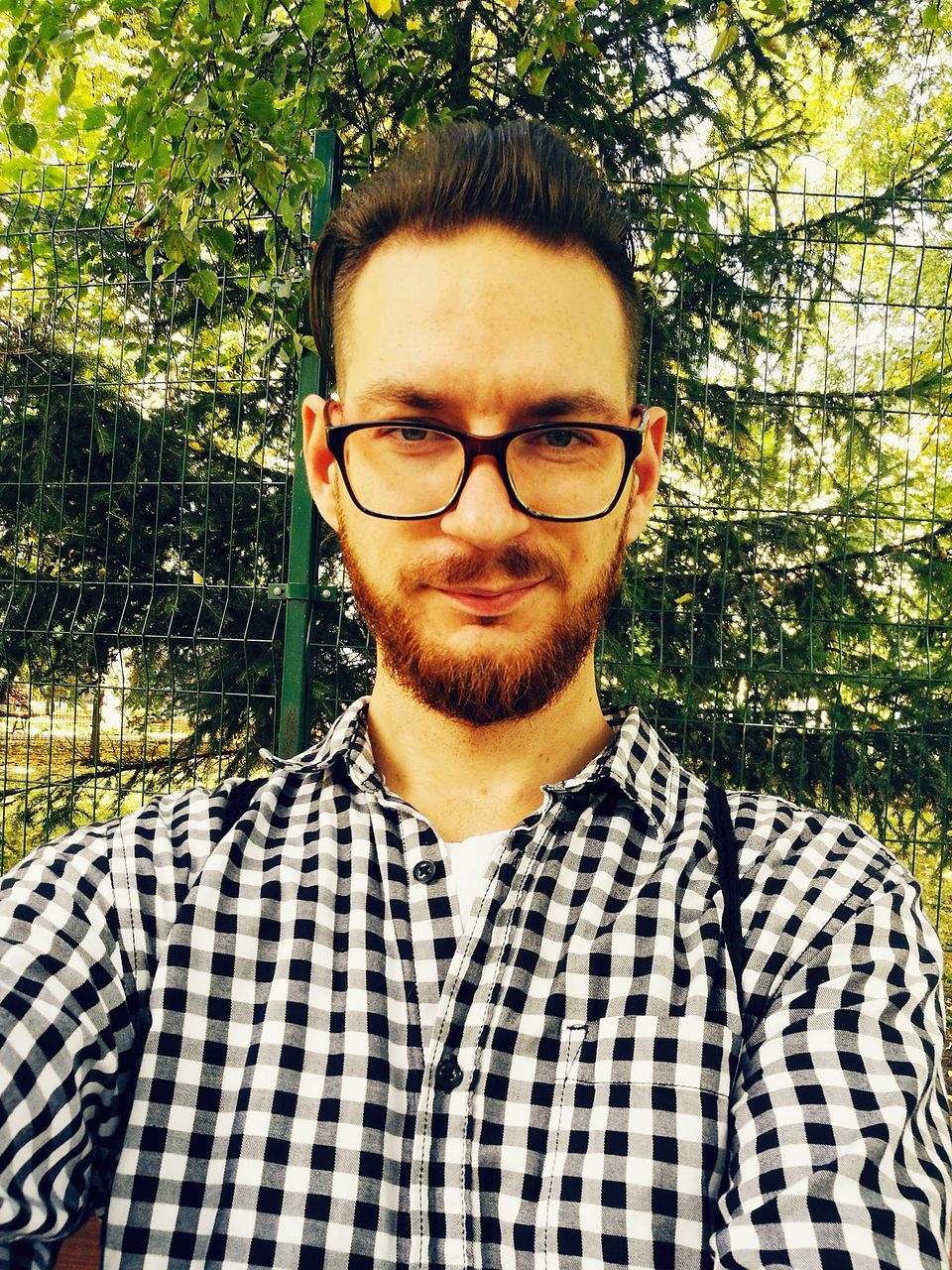 portrait, glasses, eyeglasses, looking at camera, young men, young adult, front view, one person, real people, beard, headshot, facial hair, plant, tree, leisure activity, lifestyles, nature, checked pattern, outdoors