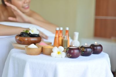 Close-up of woman sitting on table