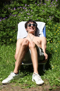 Portrait of smiling young woman sitting outdoors