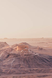 Old buildings against clear sky during sunset