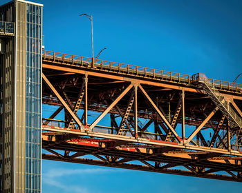 Low angle view of bridge against blue sky