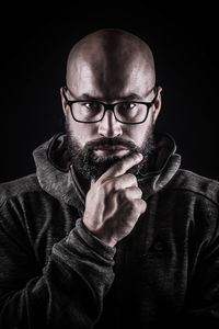 Portrait of confident man against black background