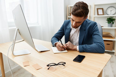 Side view of man working on table
