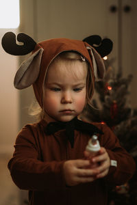 Portrait of cute boy holding hat