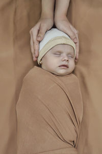 Cute baby girl sleeping on bed