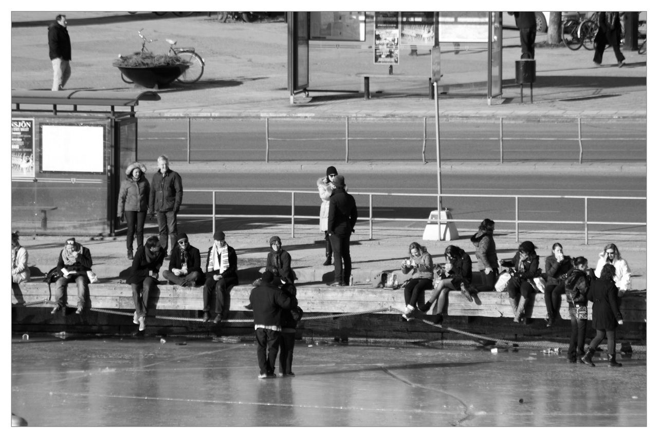 PEOPLE WALKING ON RAILROAD STATION PLATFORM