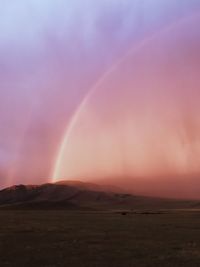 Scenic view of rainbow against sky during sunset