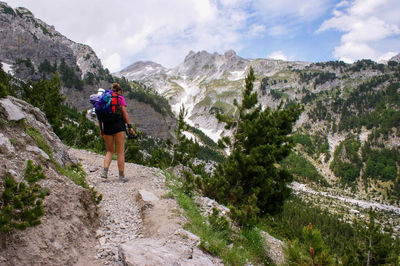 Rear view of man walking on mountain