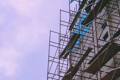 Low angle view of metallic structure against sky at dusk