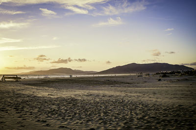 Scenic view of beach against sky during sunset