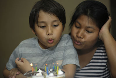 Close-up of mother and son on table