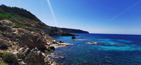Scenic view of sea against blue sky