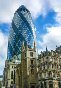 Low angle view of st andrew undershaft by 30 st mary axe against sky