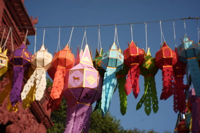 Low angle view of lanterns hanging against sky