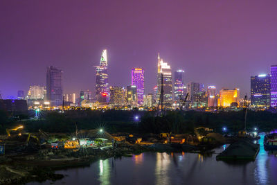 Illuminated city at waterfront