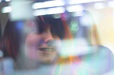 Close-up portrait of smiling young woman