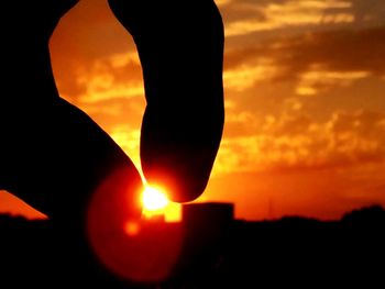 Close-up of silhouette sun against sky during sunset