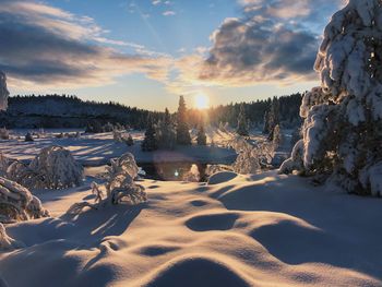 Scenic view of snow covered mountains against sky during sunset