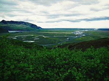 Scenic view of landscape against cloudy sky