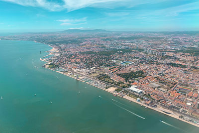 High angle view of townscape by sea against sky