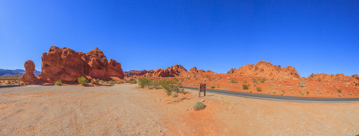 Rock formations in desert against clear blue sky