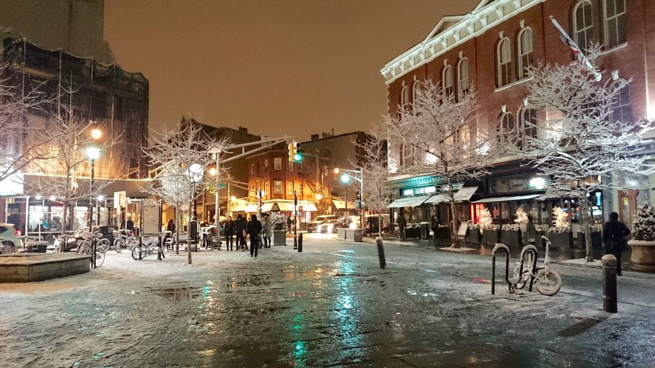 PEOPLE ON WET STREET IN CITY DURING RAINY SEASON