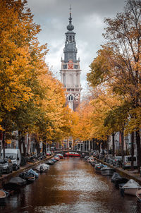 Canal amidst trees and buildings during autumn