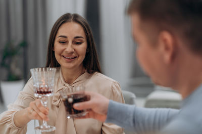 Portrait of young woman drinking glass