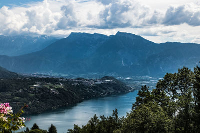 Scenic view of sea and mountains against sky