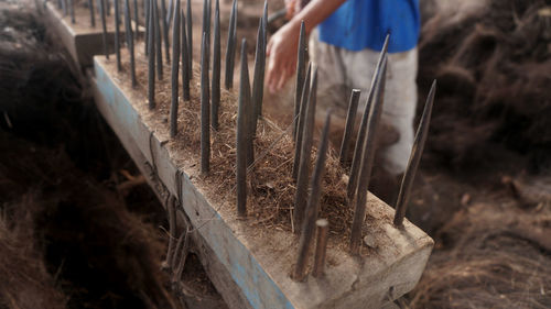 Man working on wood in field